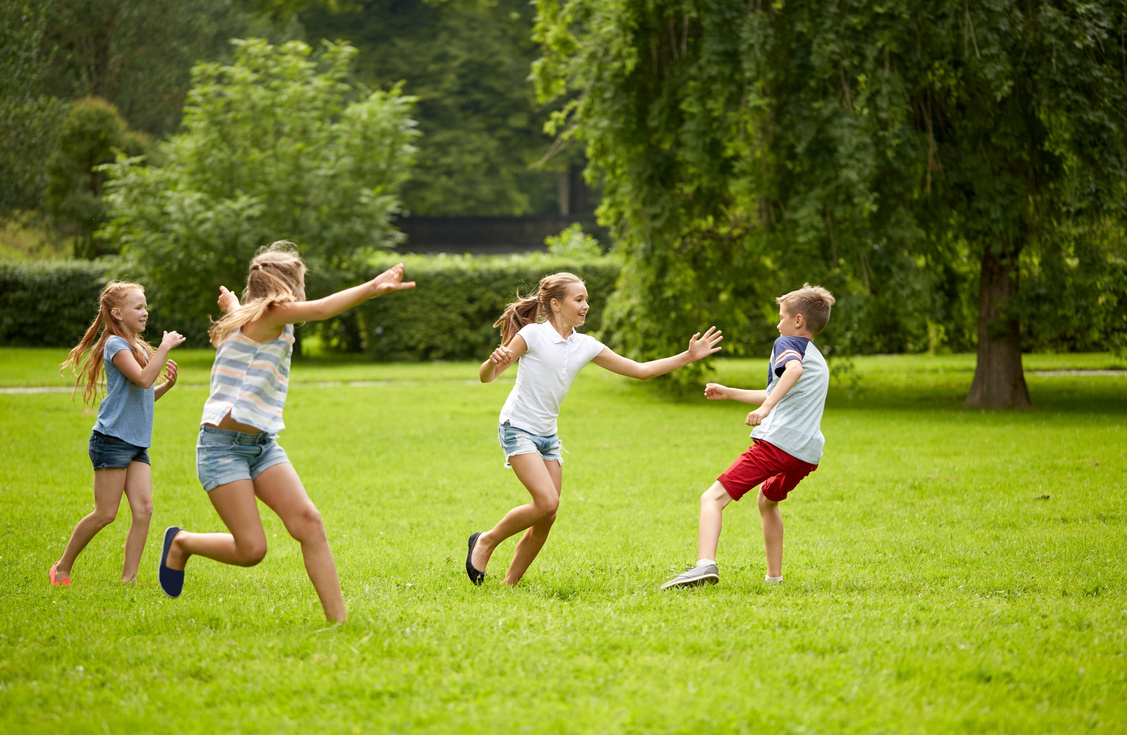 Happy Kids Running and Playing Game Outdoors